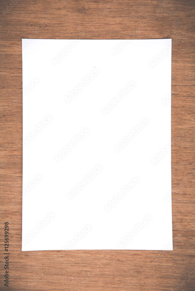 Close up White notebook paper on grunge wood background Close up White notebook paper on grunge wood background
