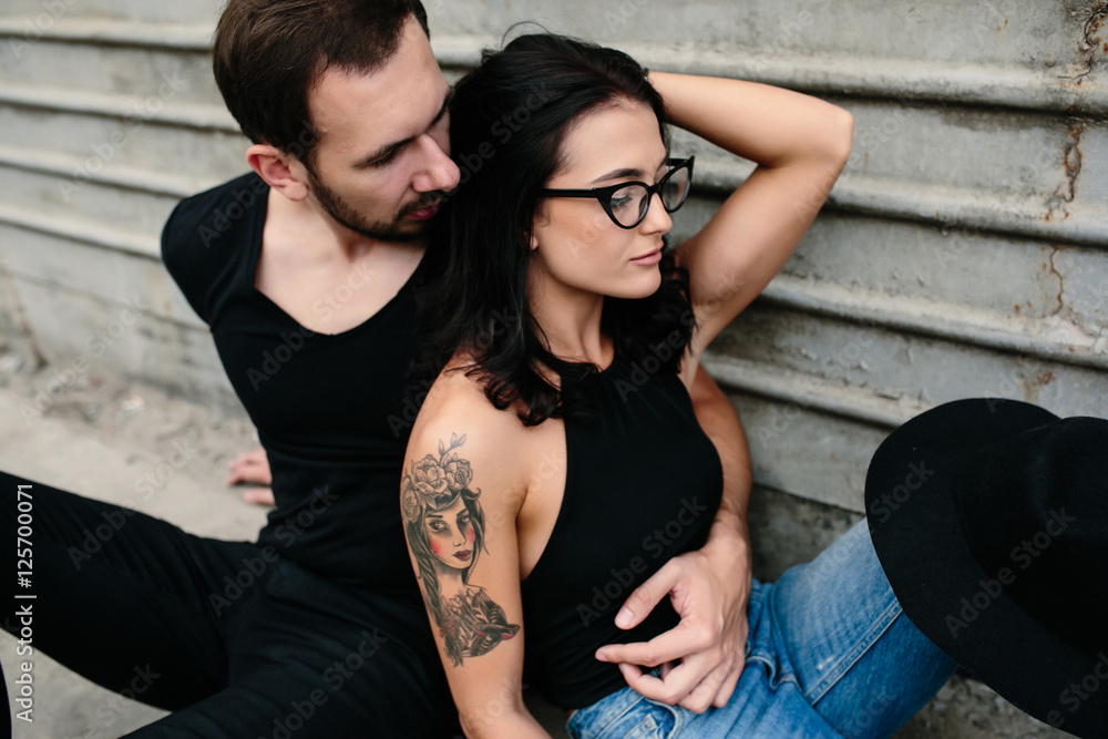 man and woman posing on a background gray wall man and woman posing on a background gray wall