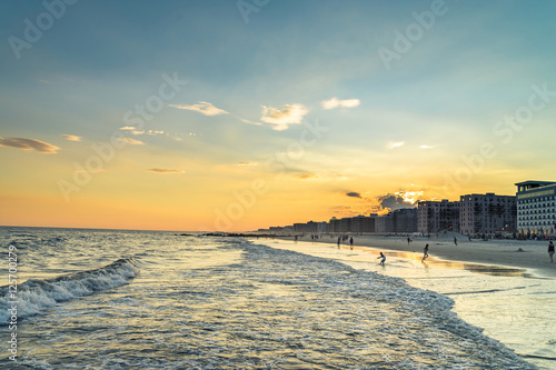 Long beach at the evening. Summer weather, splittoned image photo