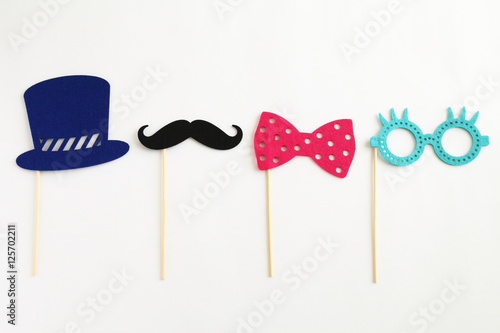 Photo booth colorful props for party - glasses, mustache, hat, ribbon on white background