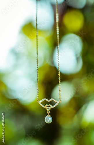 beautiful gold necklace with a pendant in the form of pearls