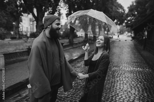 guy and girl under an umbrella © teksomolika