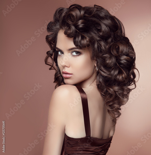 Beauty brunette portrait. Curly Hair. Makeup. Attractive girl wi