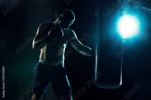 Male boxer boxing in punching bag © master1305