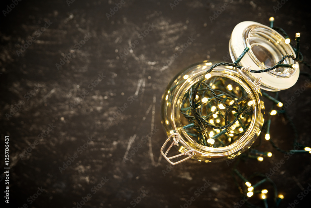 Christmas garland in the jar. View from above. Dark background with empty space