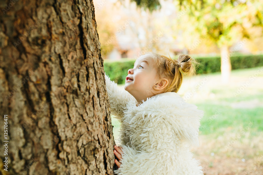 Cute little girl is playing outdoors Cute little girl is playing outdoors