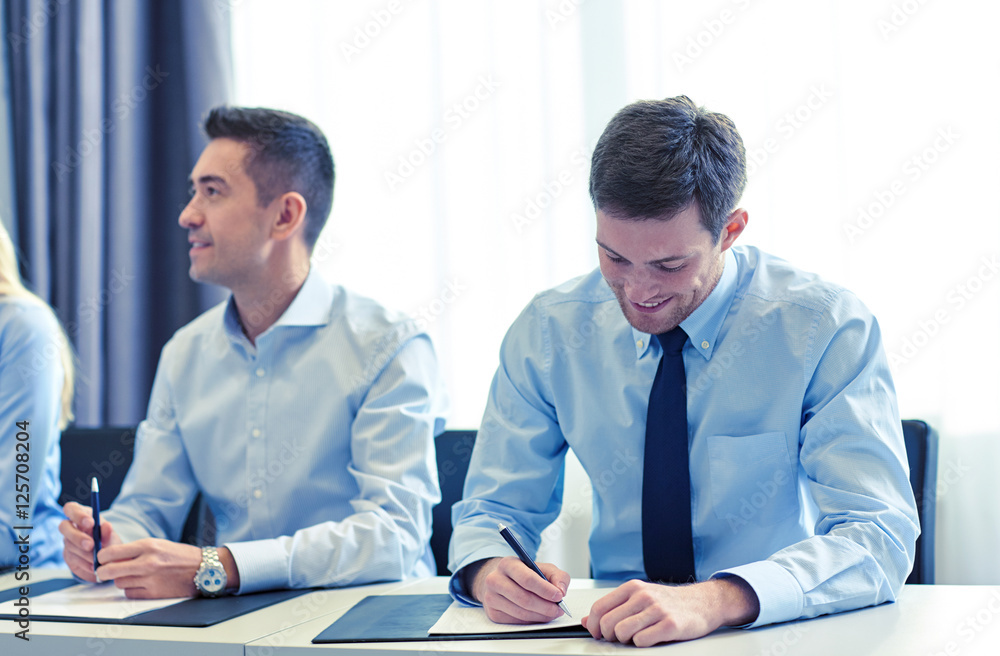 group of smiling businesspeople meeting in office group of smiling businesspeople meeting in office