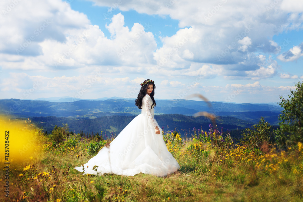 Beautiful girl in a dress walking in the mountains. Beautiful girl in a dress walking in the mountains.
