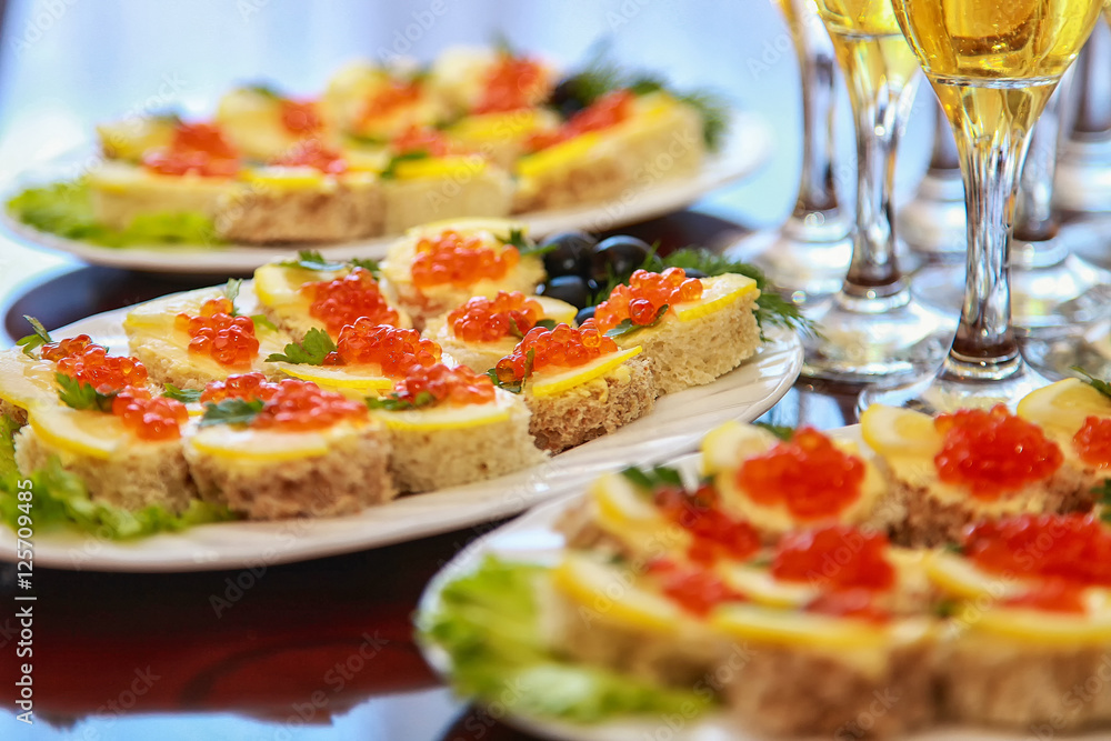 sandwiches with red caviar and champagne on the table sandwiches with red caviar and champagne on the table