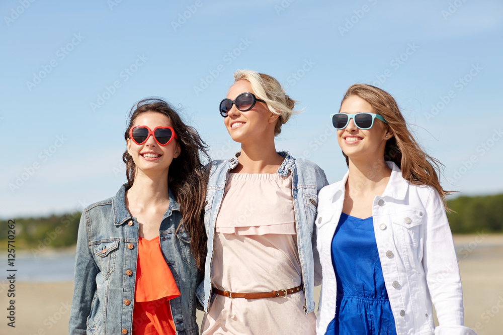 group of smiling women in sunglasses on beach group of smiling women in sunglasses on beach