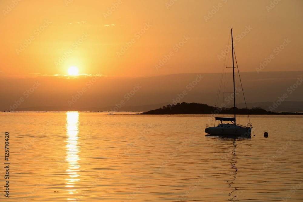 sailing yacht on the background of sunset