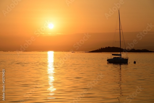 sailing yacht on the background of sunset