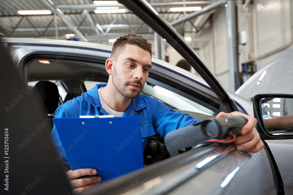 mechanic man with diagnostic scanner at car shop mechanic man with diagnostic scanner at car shop