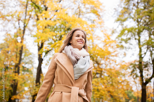 beautiful happy young woman walking in autumn park