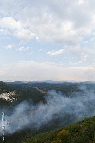 Panoramic view of forest valley with clouds