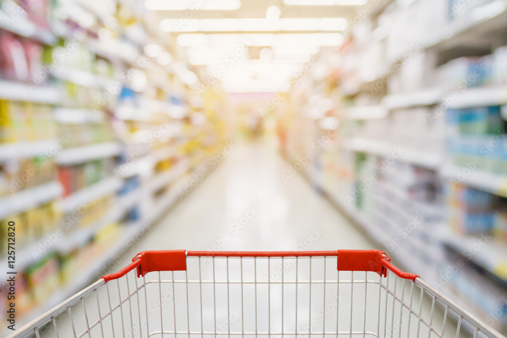 Supermarket aisle with red shopping cart