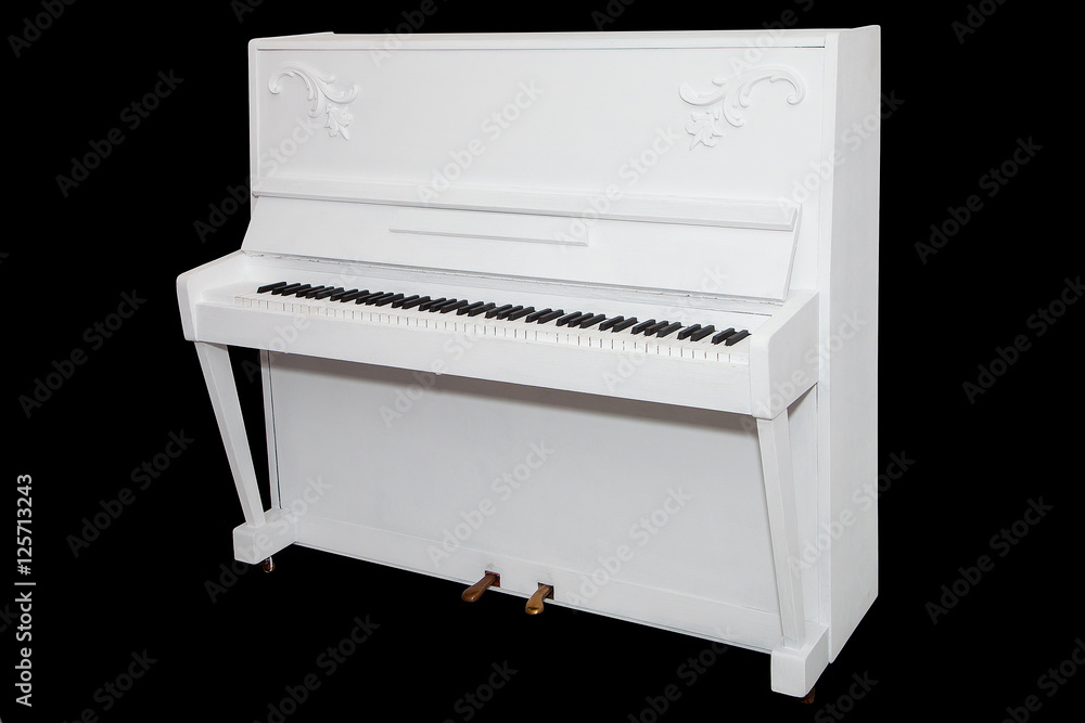 white piano isolated on a black background white piano isolated on a black background