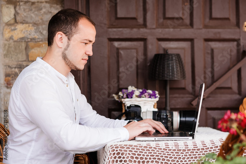 Man is looking at laptop with excitement. photo