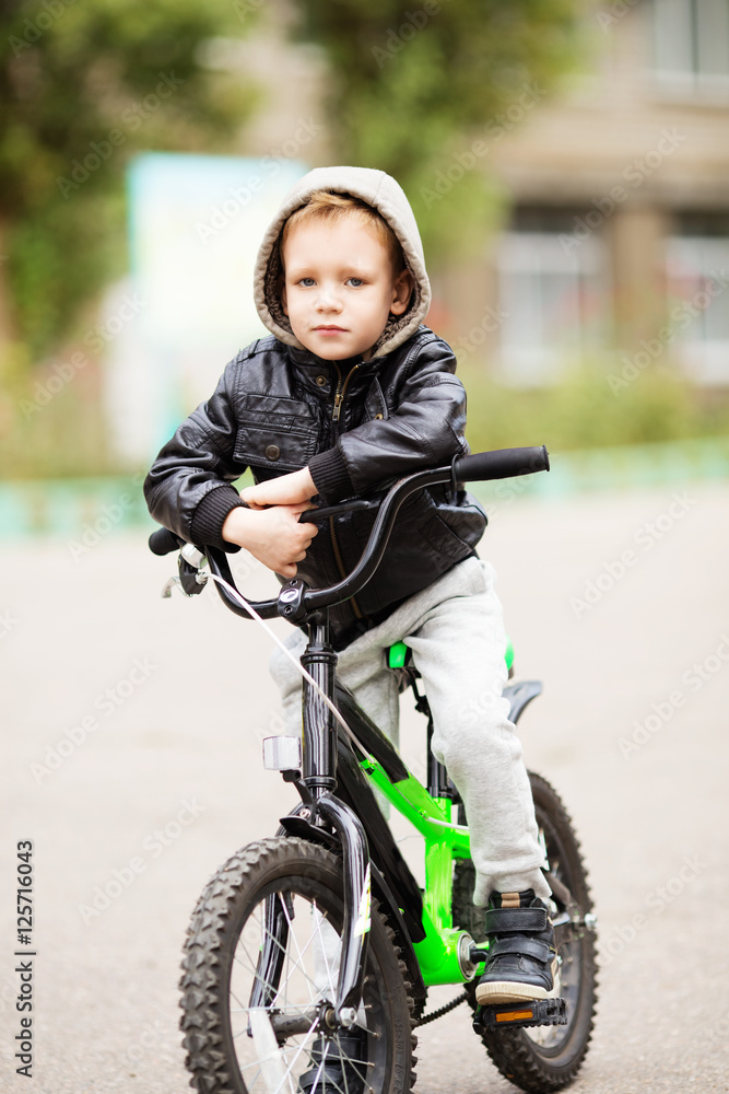 The boy learns to ride a bike. The boy learns to ride a bike.