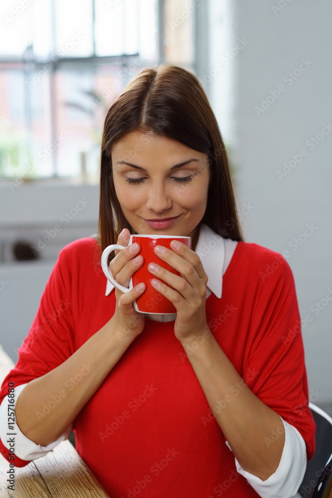 frau genießt eine tasse tee mit geschlossenen augen frau genießt eine tasse tee mit geschlossenen augen