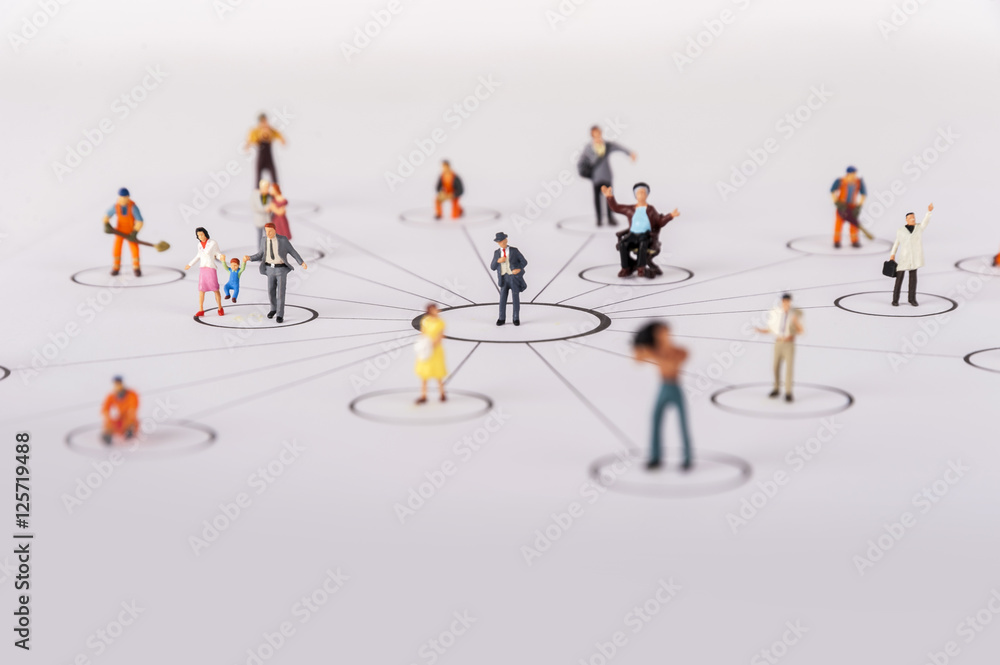 close up of miniature people with social network diagram close up of miniature people with social network diagram