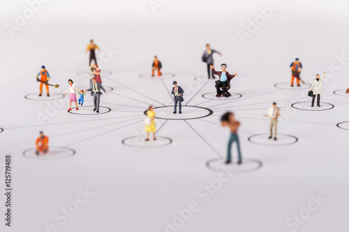 close up of miniature people with social network diagram