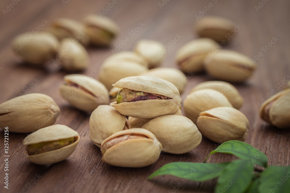 Pistachios on wooden table Pistachios on wooden table