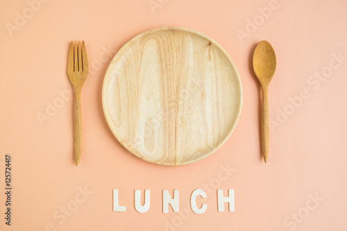 Top view of wooden cutlery with lunch word