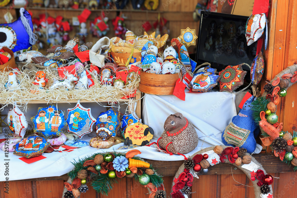 Colorful close up details of christmas fair market. Knitted balls decorations for sales.