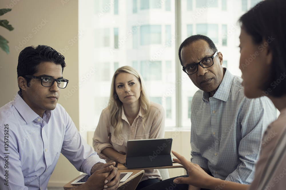 Business people in meeting having interesting discussion Business people in meeting having interesting discussion