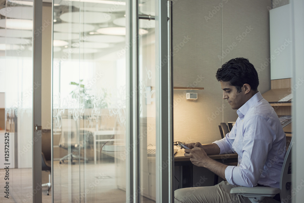 Businessman working in office using smart phone Businessman working in office using smart phone
