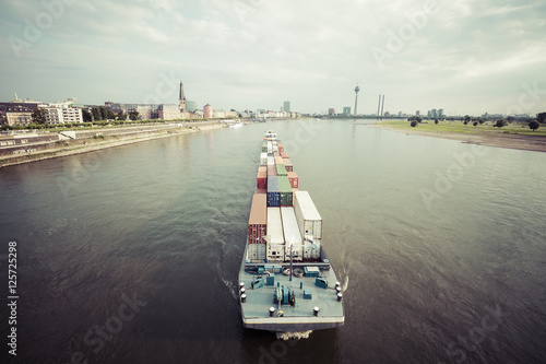 Germany, Duesseldorf, cargo ship transporting containers at Rhine River