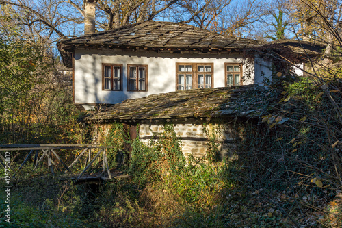 Autumn landscape with wooden Bridge and old house in village of Bozhentsi, Gabrovo region, Bulgaria