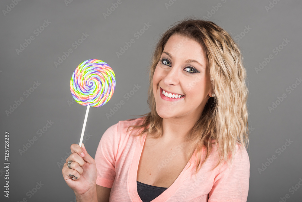 Young smiling woman with lollipop
