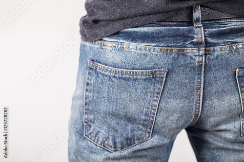 A man with his hands in jeans pockets