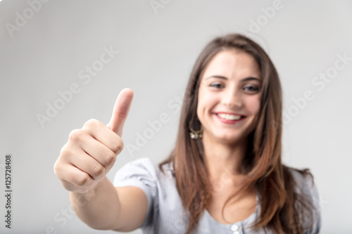 Wallpaper Mural Smiling attractive woman giving a thumbs up Torontodigital.ca