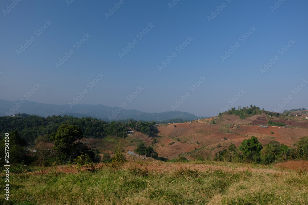 Beautiful mountain landscape, with mountain peaks covered with forest and a blue sky.