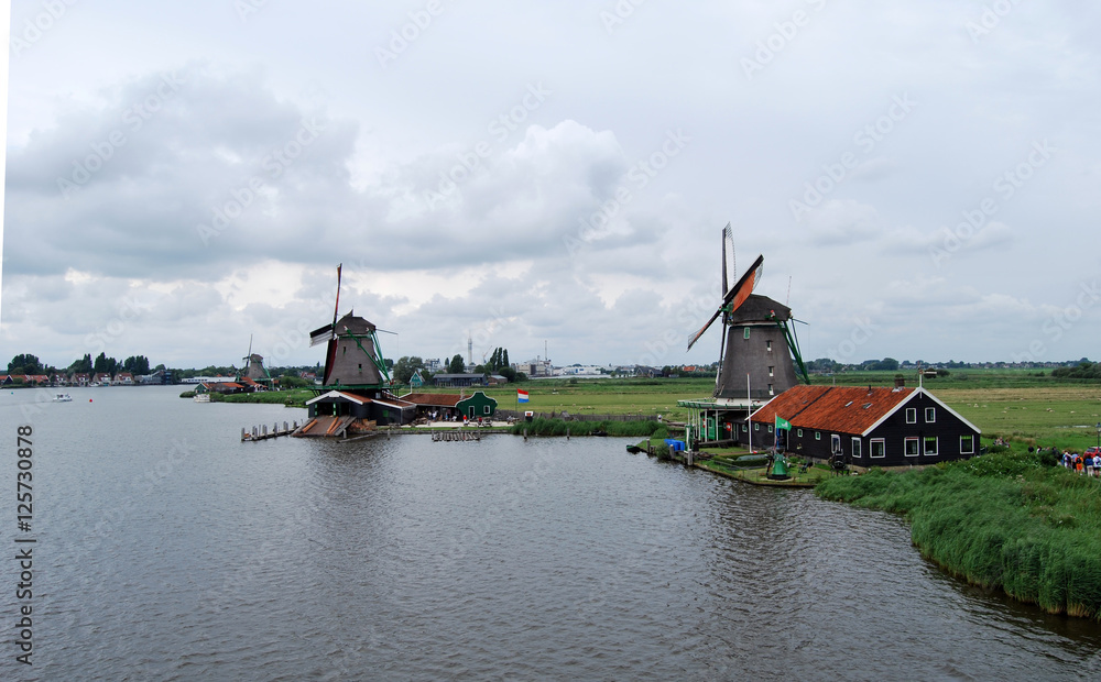 Traditional Dutch old wooden windmill in Zaanse Schans - museum village in Zaandam (Traditional village in Holland in Netherlands)
