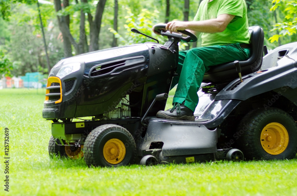 Man is riding the grass cutter Man is riding the grass cutter