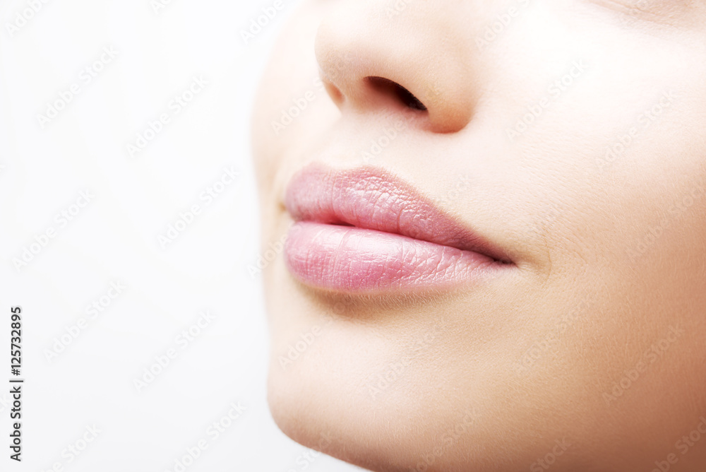 Plump sexy lips and perfect skin on a white background