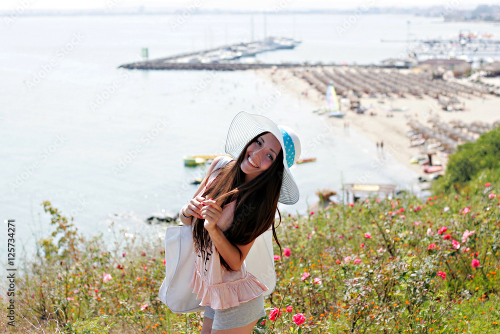 Fototapeta premium Beautiful girl in blue hat smiling and posing for the camera