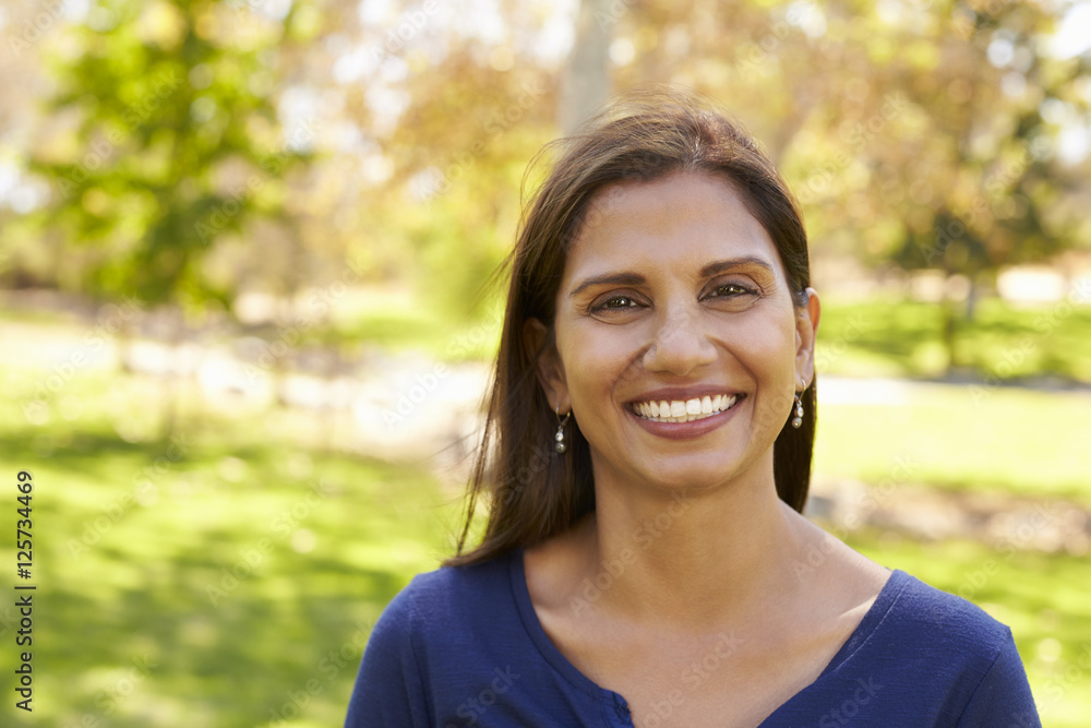 Mixed race Asian Caucasian woman in park looking to camera Mixed race Asian Caucasian woman in park looking to camera