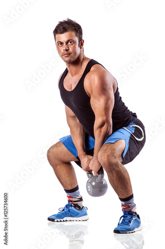 Sexy athletic man showing muscular body with weight, full length