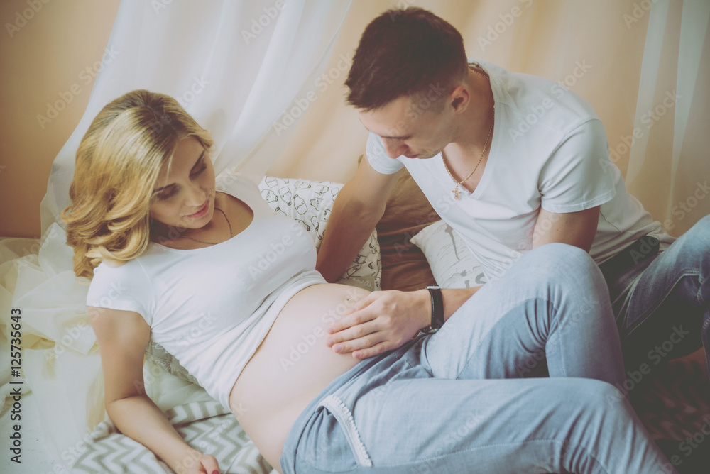 Young pregnant woman and her husband Young pregnant woman and her husband