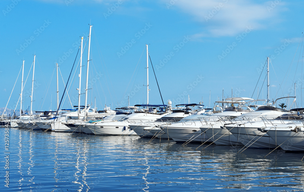 Many luxury yachts and boats in the harbor.