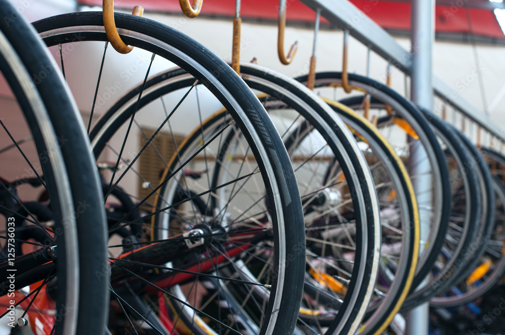 Many of bicycle wheels. Bike rental service.