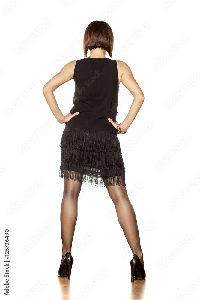 full figure of middle aged woman in short black dress. back view full figure of middle aged woman in short black dress. back view