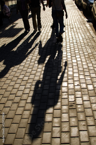 Long girl's shadow on the street 