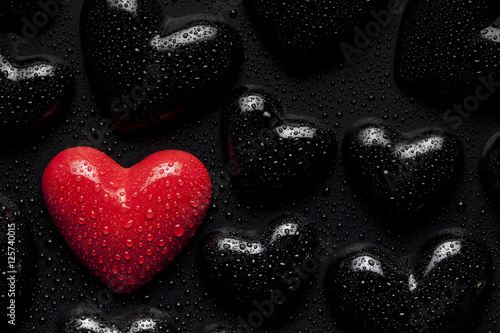 One red heart on black background