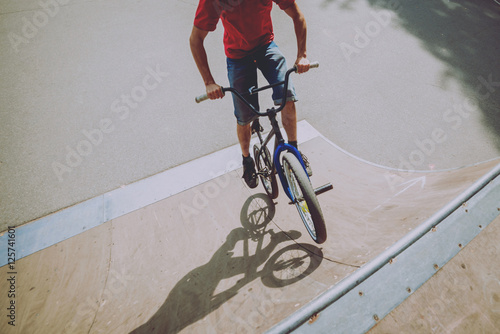 Boy riding a bmx in a park. © romaset